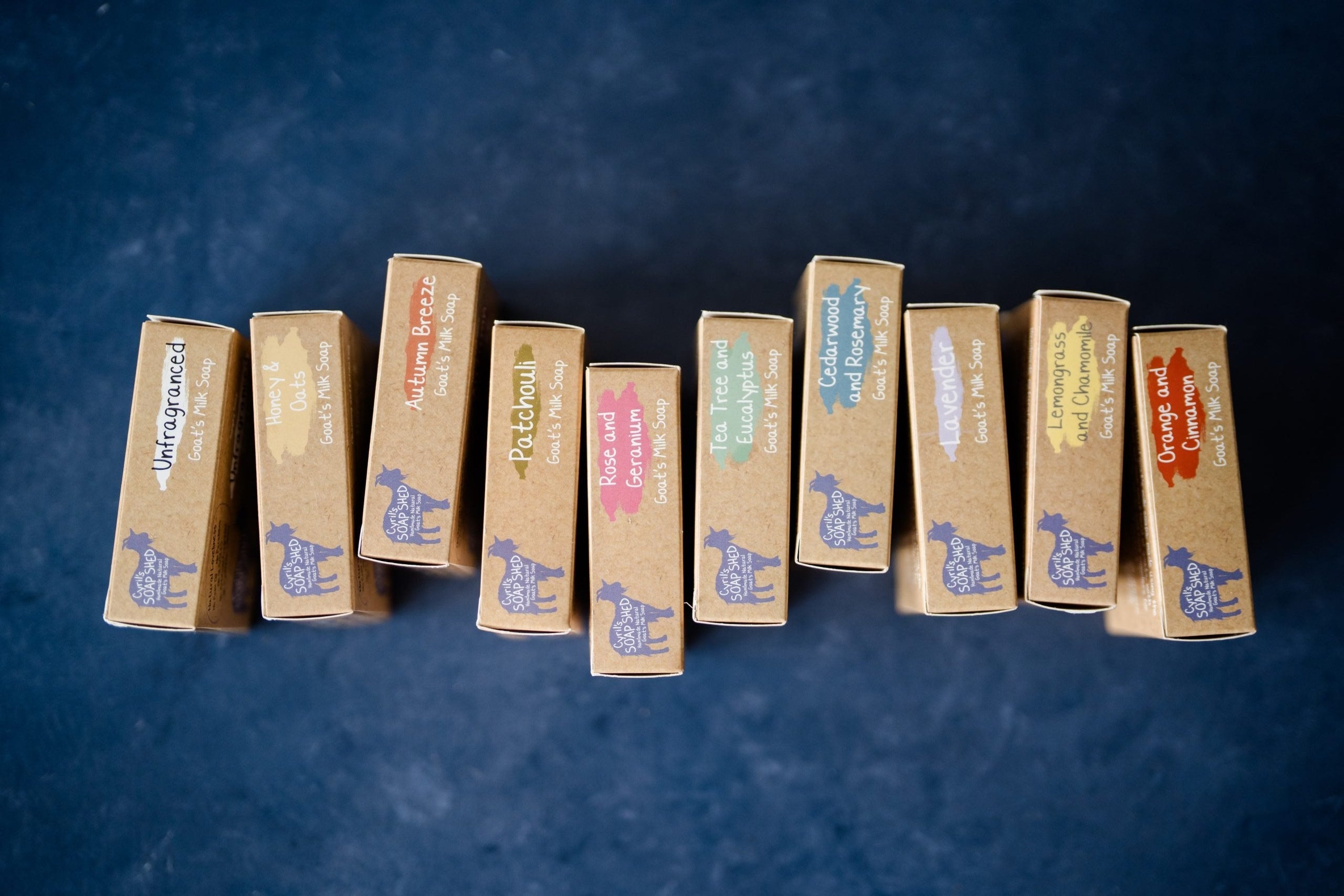 Row of soap bars with labels on a dark blue background